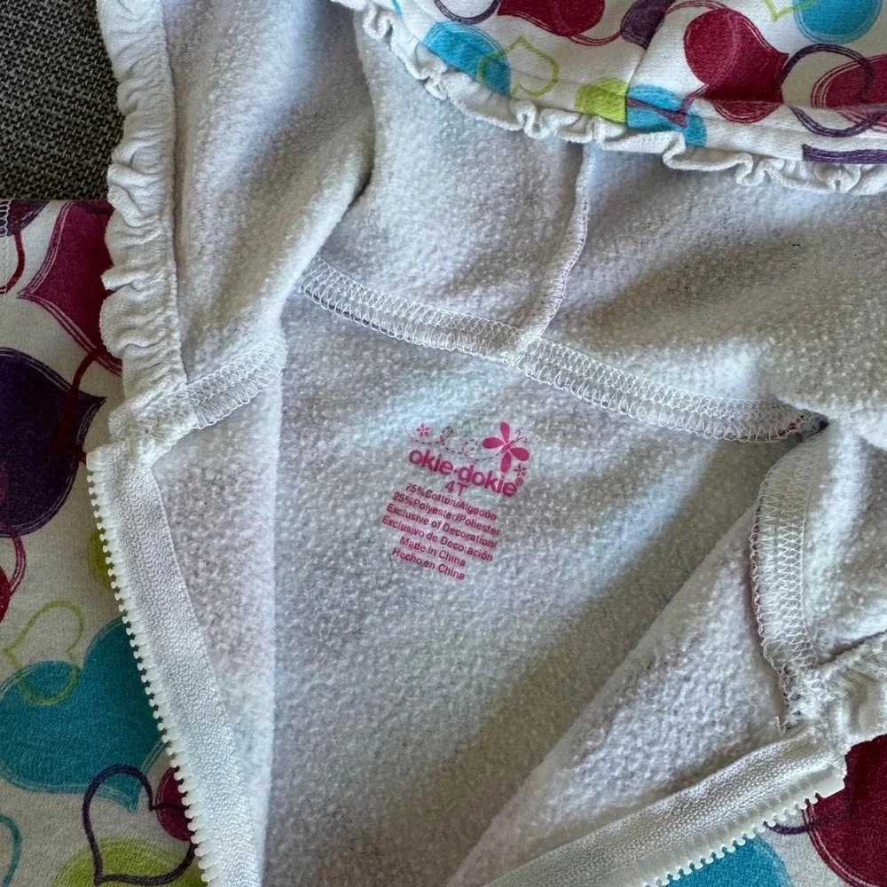Okie-dokie Multi-colored heart print zip-up hoodie.